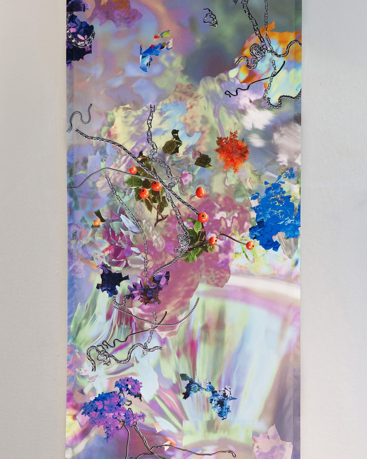 Detail of the printed banner: orange berries, blue flowers and silver chains on an iridescent pastel ground