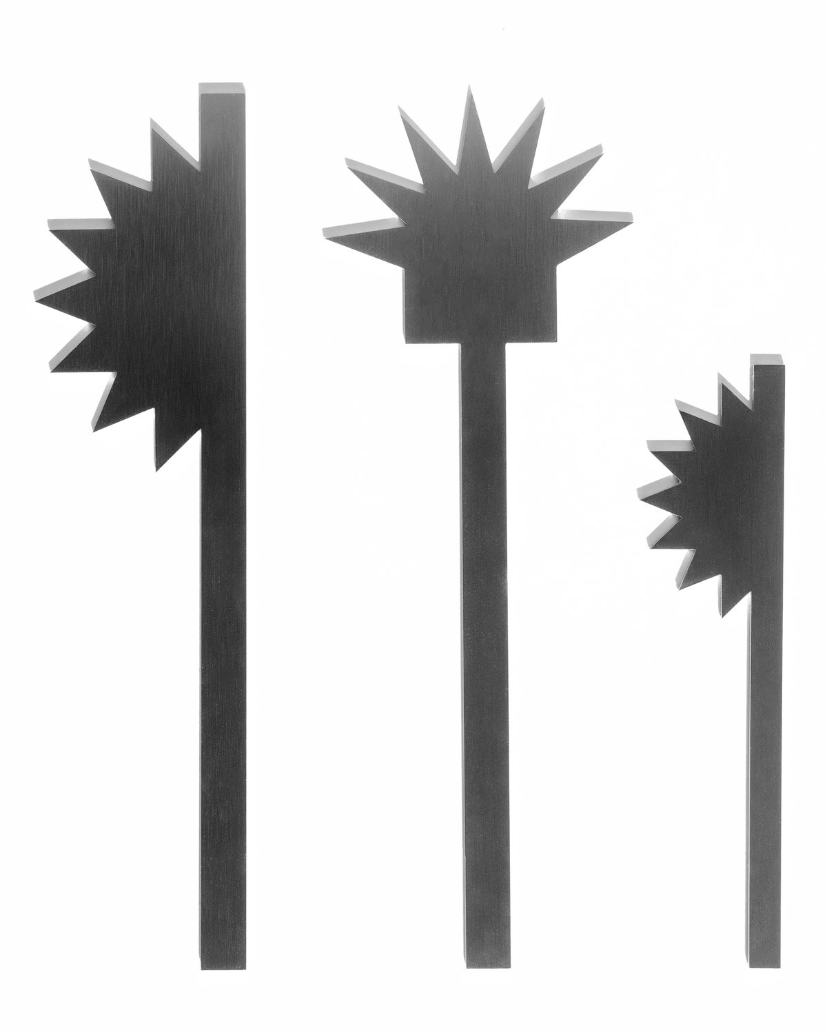 Three Spikey pieces side by side, each a long steel stem with a spiky half or full star