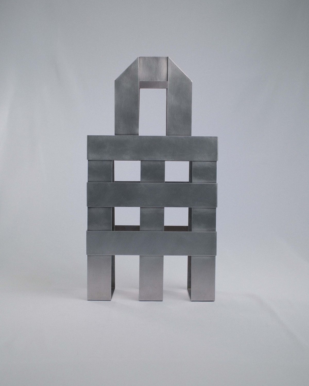 Brushed aluminium bag in the shape of a woven shopping bag