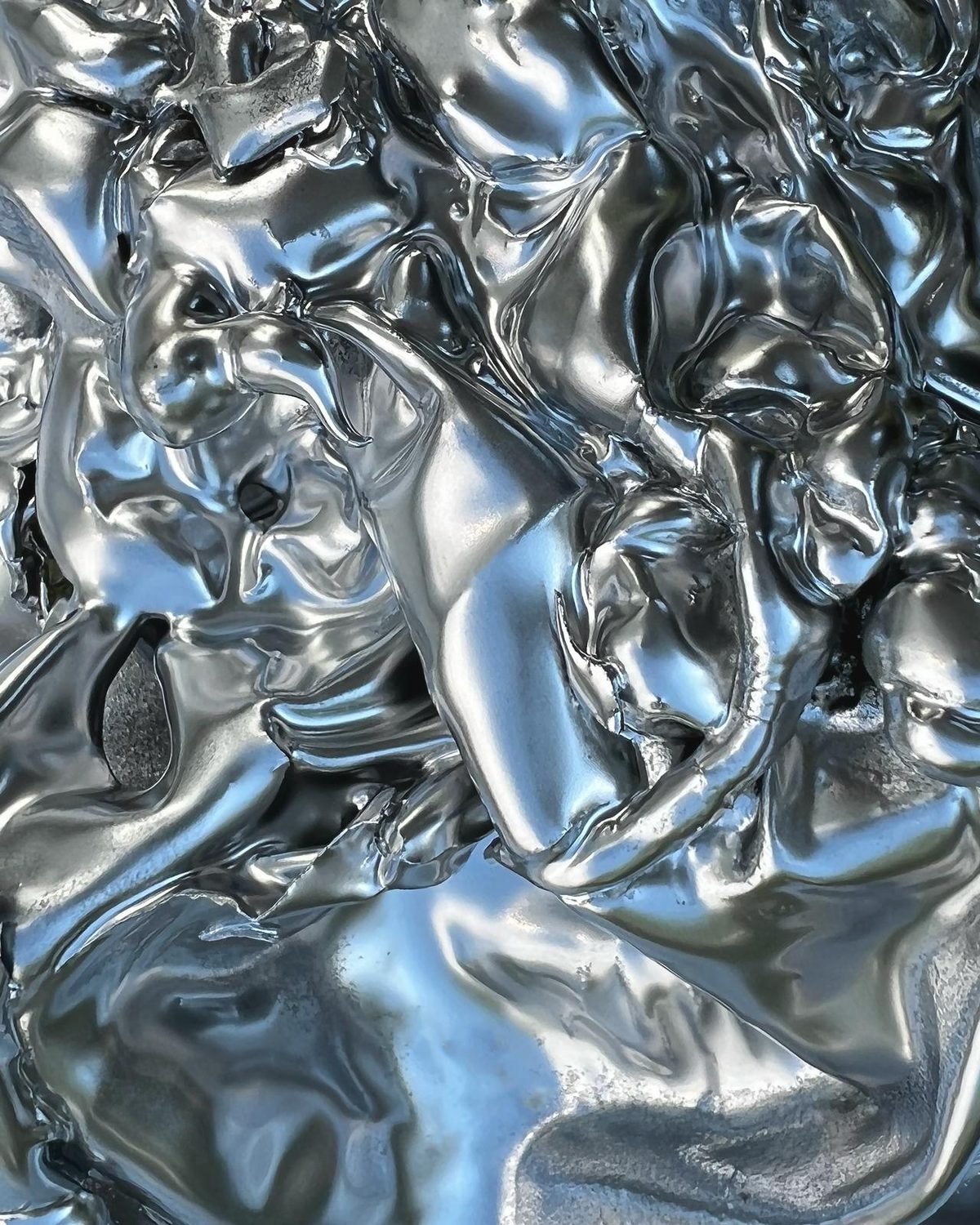 Close-up of a glossy, crumpled silver surface