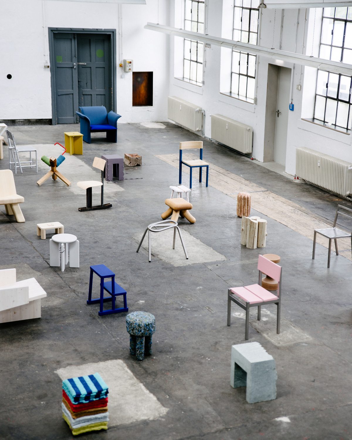 Stools and chairs spread across the concrete floor of the ZIRKA hall, seen from above